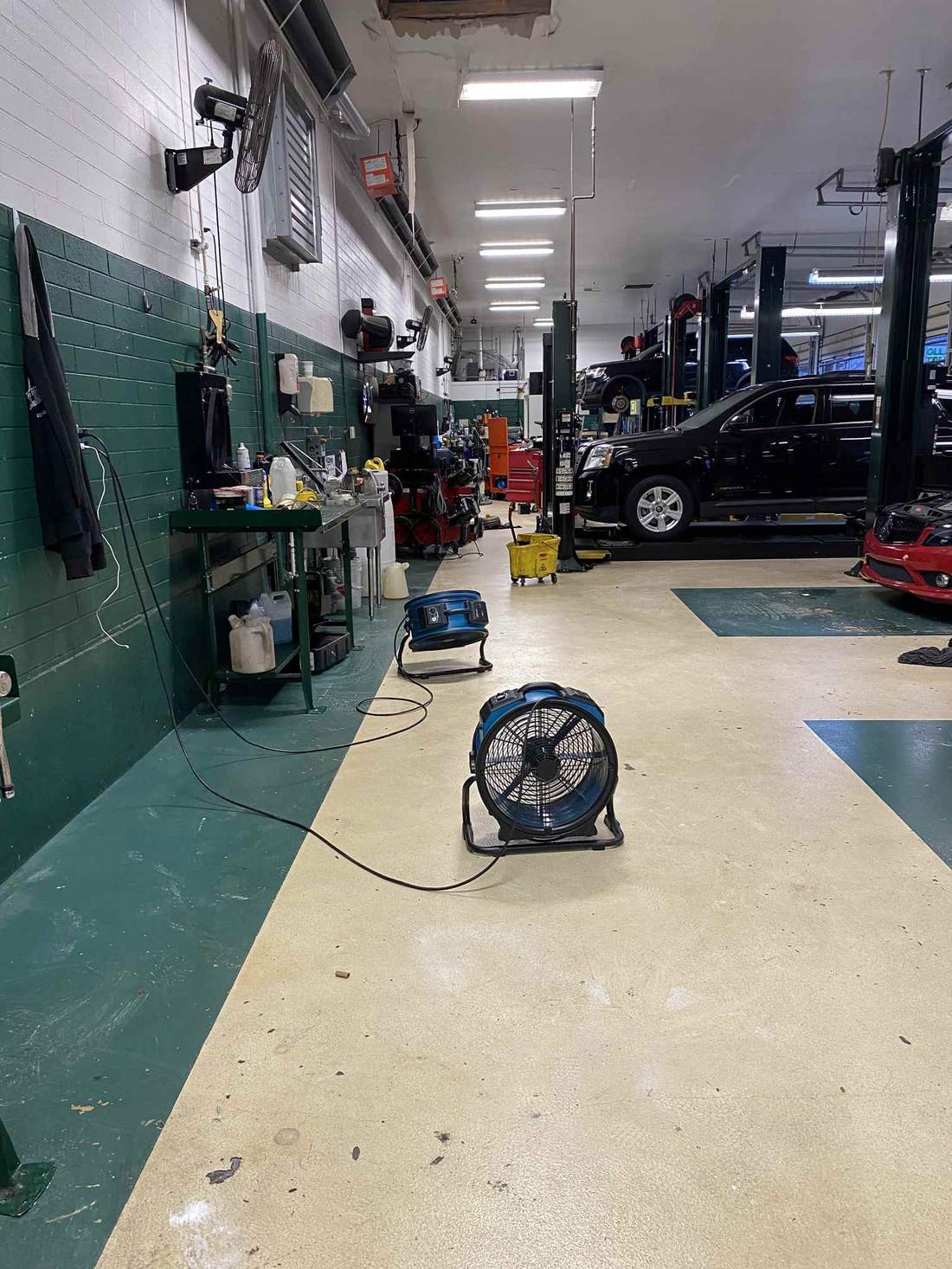 Axial fans drying the floor of a commercial automotive shop