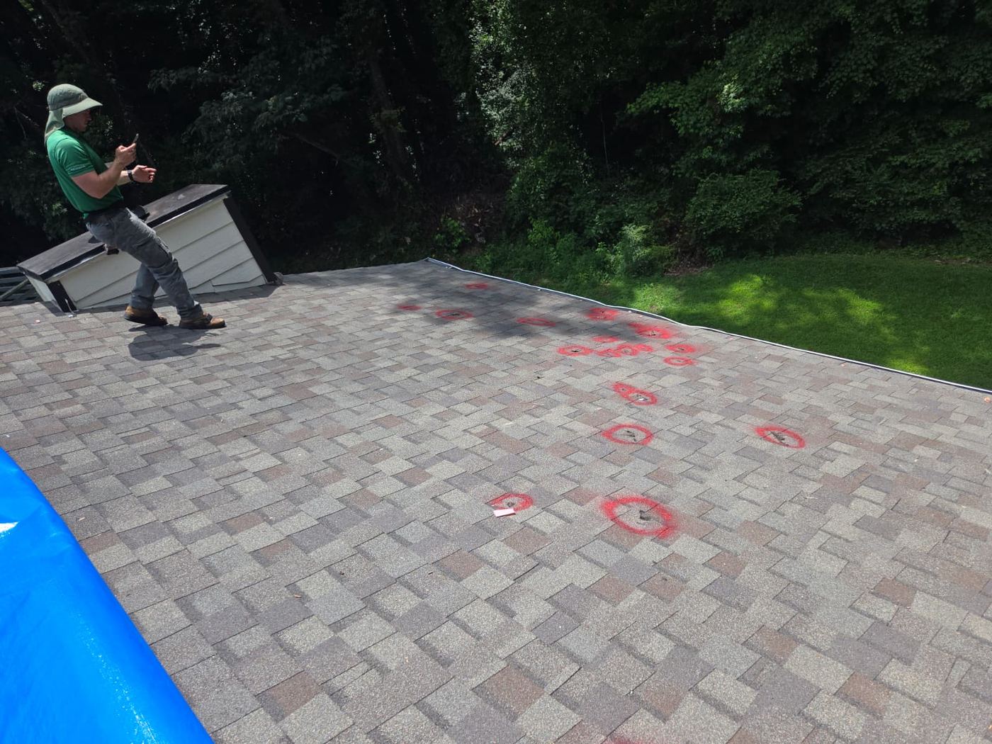 Roof damage locations marked during inspection and documentation
